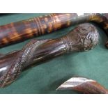Carved African ebony tribal stick, carved snake eating a lizard. Estimate £15-20