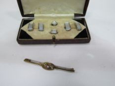 Mother of pearl cufflinks & studs (boxed) & a rolled gotted tie pin with purple stone. Estimate £