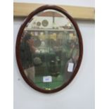 Mahogany framed oval bevel edge mirror, 59cms x 44cms. Estimate £10-20
