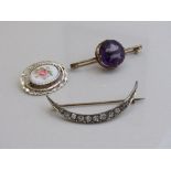 Large purple stone set in gold coloured metal, diameter 1.8mm; a crescent shaped white metal