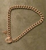 9ct gold lady's curb chain charm starter bracelet with heart lock & safety chain, weight 16.75gms.