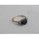 18ct gold ring set with a large sapphire with diamond on either shoulder, size P, weight 3.9gms.