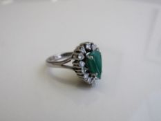 18ct white gold ring set with a pear shaped cloudy emerald & 14 diamonds, size K 1/2, weight 8.6gms.