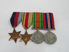 WWII medal group on bar includes The Africa Star set of 4 medals, all original. Estimate £40-60