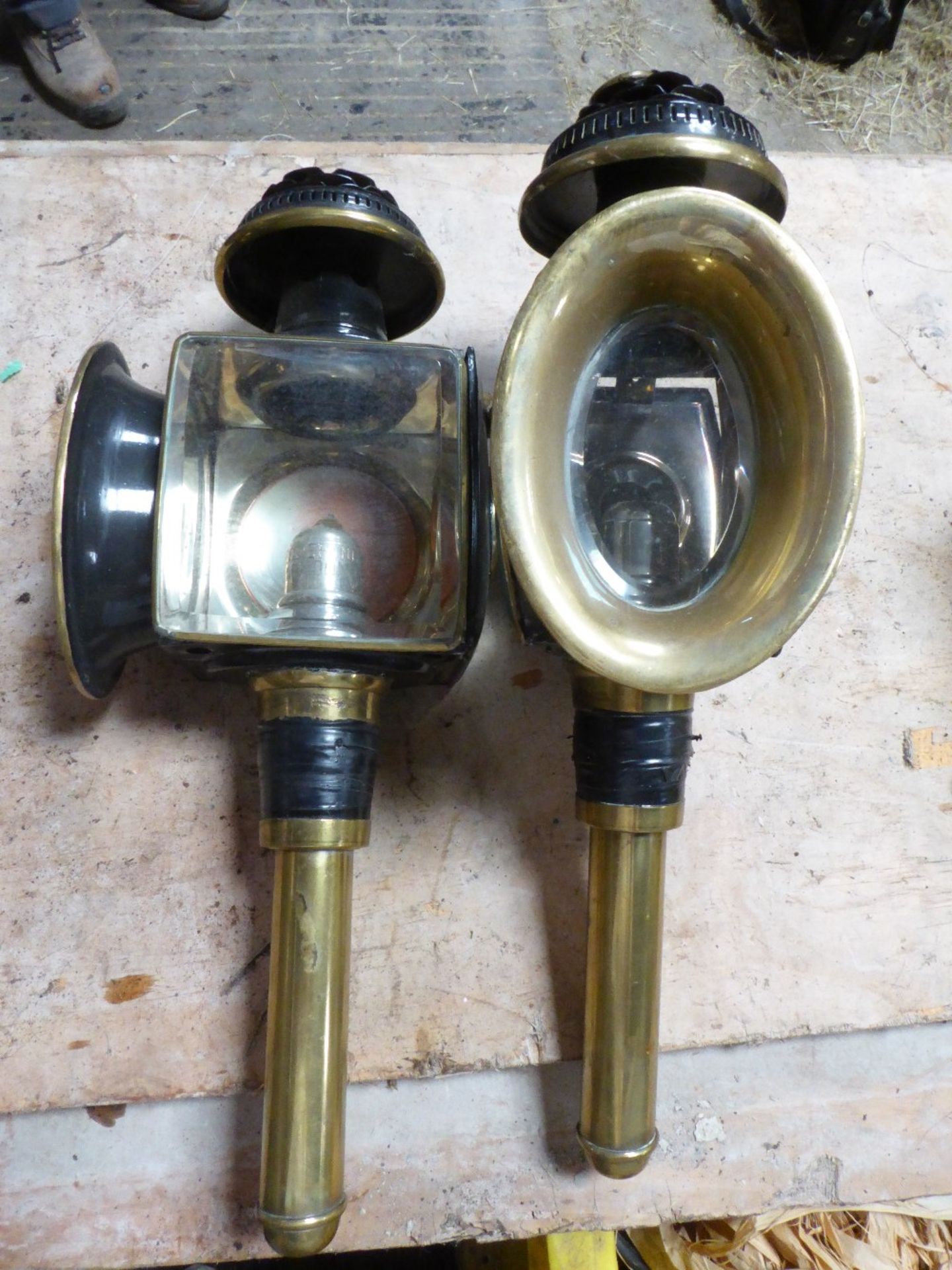 Pair of black carriage lamps by Pickering of London with brass trim, oval fronts and bevelled