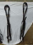 Pair of black leather back straps and cruppers with brass buckles