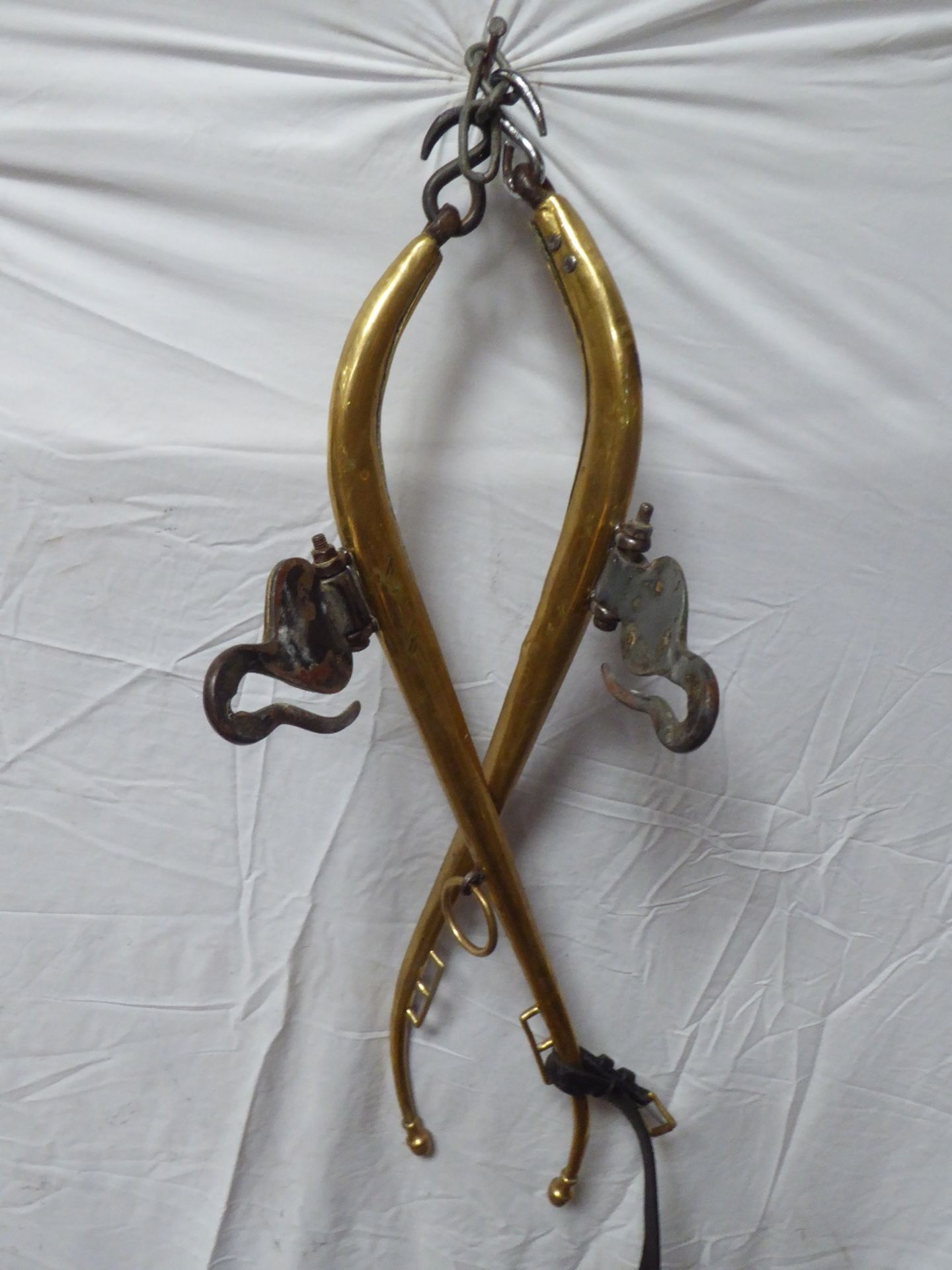 Pair of solid brass hames with leather straps and acorn tops