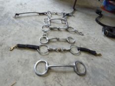 6 varous stainless steel riding bits; 5 snaffles and a pelham