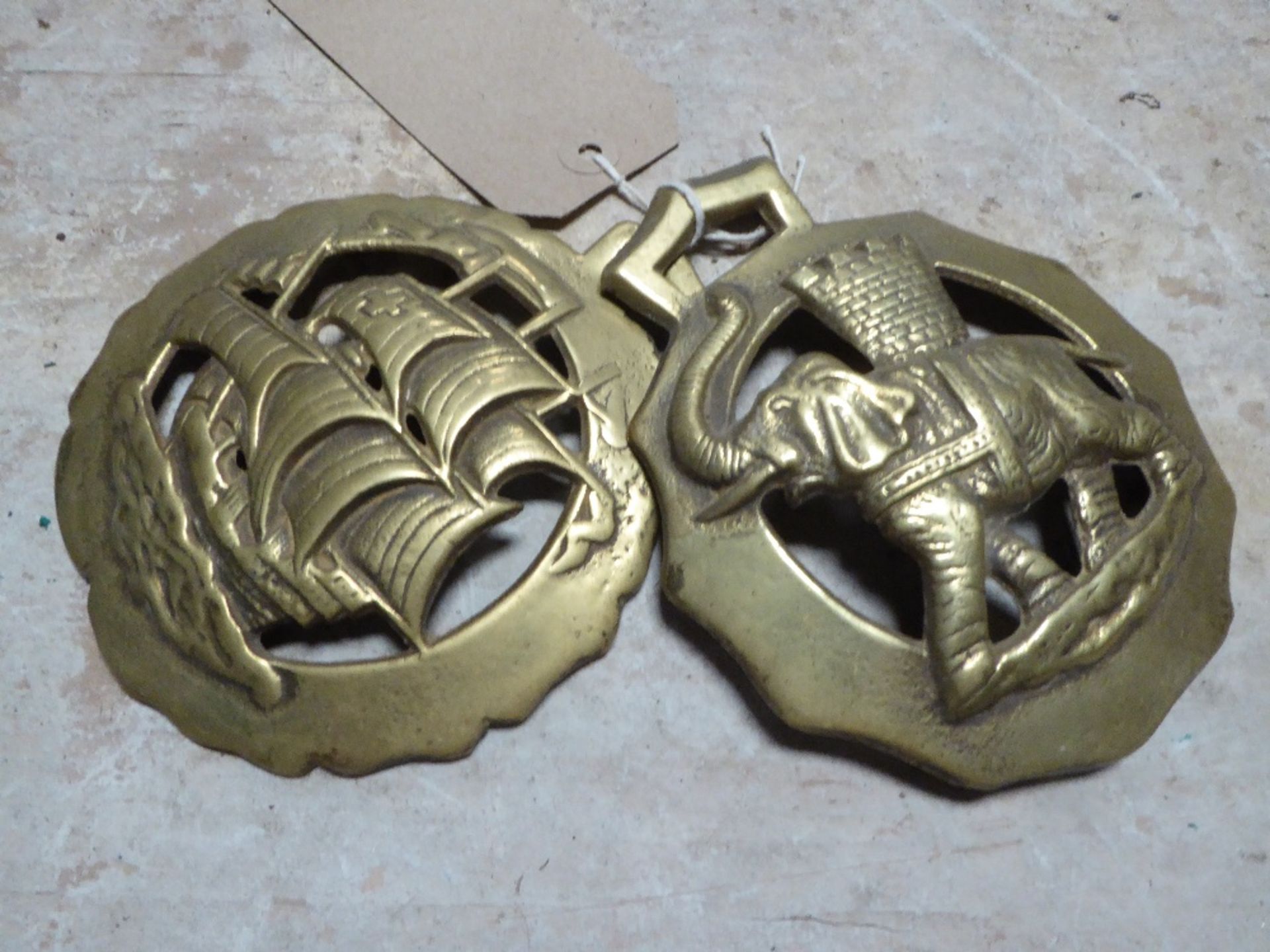 Pair of large horse brasses - one depicting an elephant, the other a ship