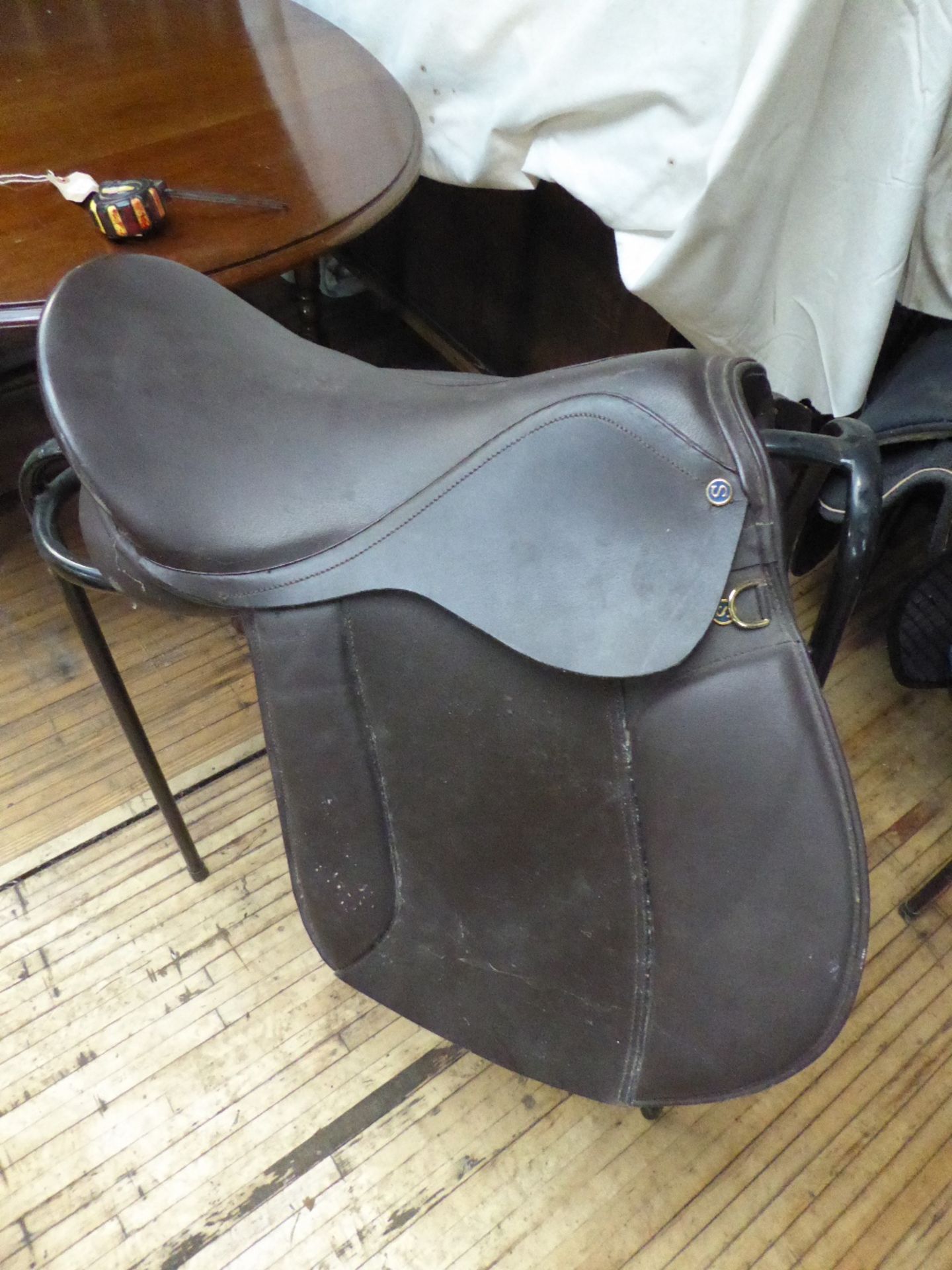 Brown leather saddle, 17ins with studs stamped 'S'