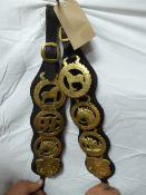 Pair of leather straps each with 4 horse brasses and brass buckles