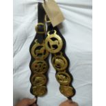 Pair of leather straps each with 4 horse brasses and brass buckles