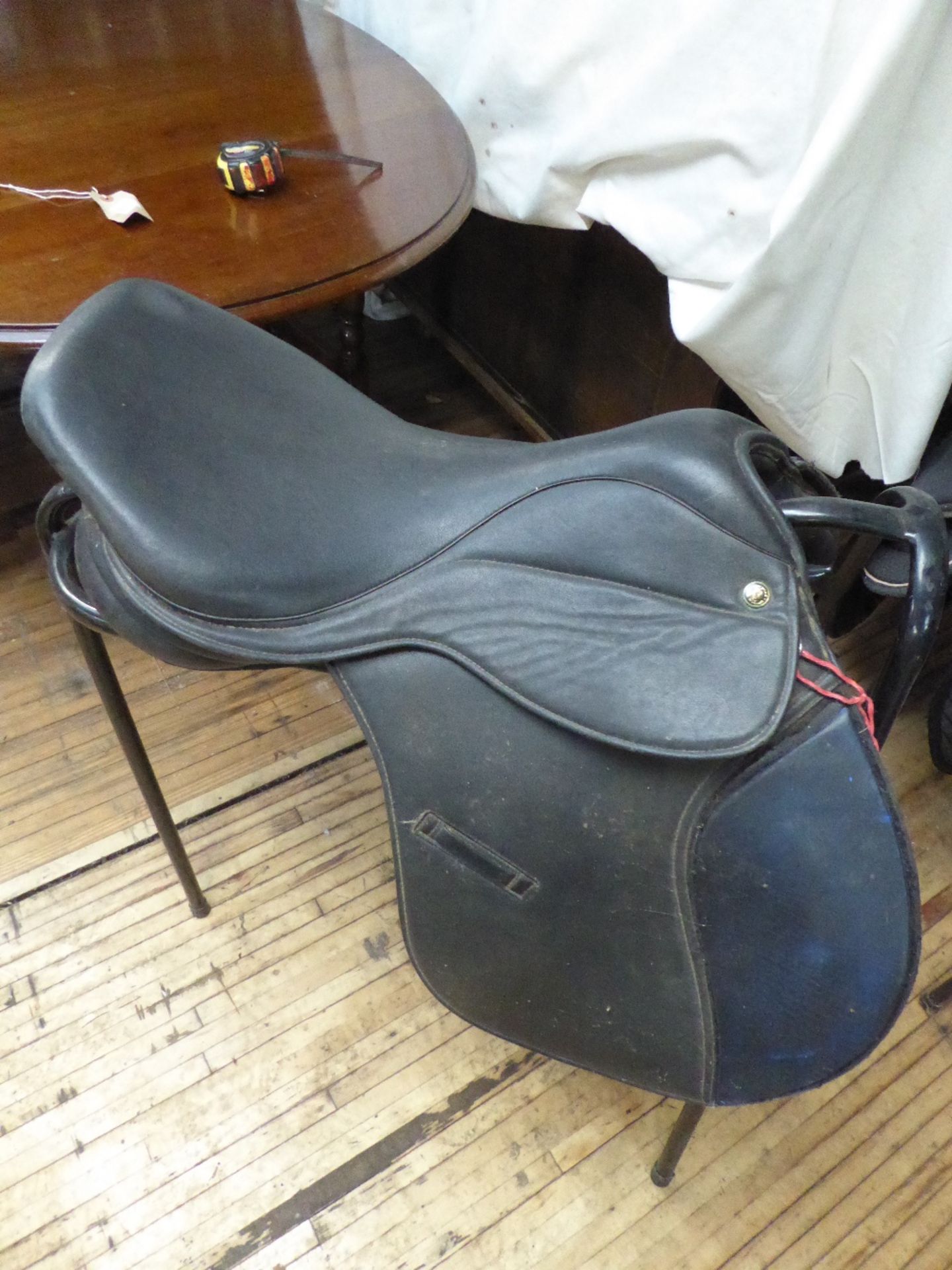 Black synthetic GP saddle, 17ins by Thorowgood of Walsall. Comes with a saddle stand
