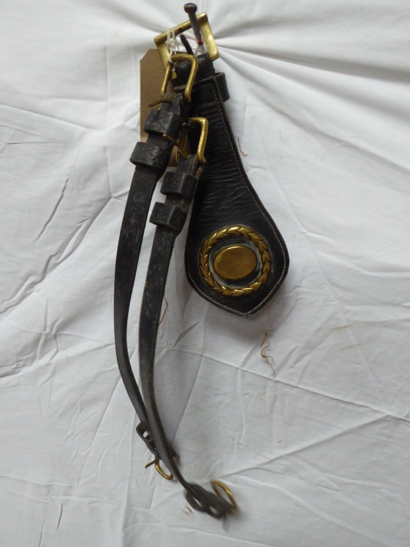 Pair of leather throat straps and one brass on leather