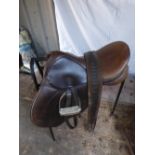 Saddle, 17ins by Crosby with stirrups, leathers and girth. Comes with a saddle stand
