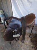 Saddle, 17ins by Crosby with stirrups, leathers and girth. Comes with a saddle stand