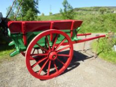 Slaithwaite Cart, the body is painted green with red side board and undercarriage, all decorated