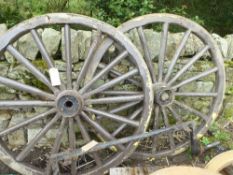 Pair of black and cream lined wheels, 53ins with rubber channels and an axle, 46ins