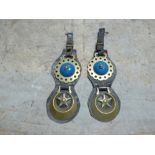 Pair of shaped leather headpieces each with a star centre crescent brass and another with a blue