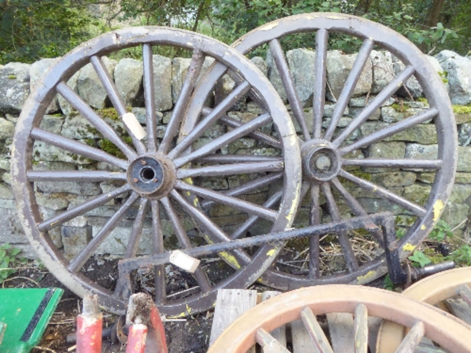 a cranked axle and a pair of metal tyred wheels