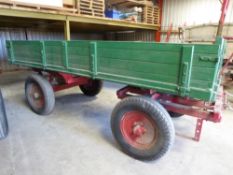 Farm Rully circa 1940's, the body is painted green with removable sides and a red undercarriage with