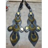 An unusual pair of shaped leathers each with three crescent horse brasses, three heart studs and