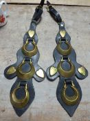 An unusual pair of shaped leathers each with three crescent horse brasses, three heart studs and