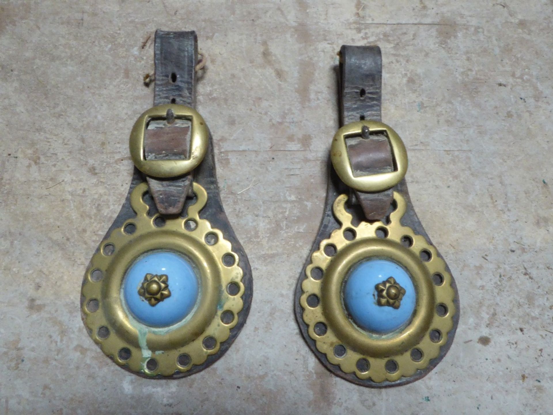 Pair of leather headpieces each with a light blue ceramic centred horse brass