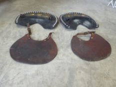 a pair of black leather hausens with 3 brass studs and 2 bibs