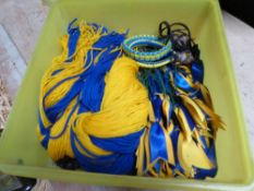 Box containing blue and yellow plaiting ribbons