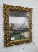 Gilt carved wood framed wall mirror, 66cms x 56cms. Estimate £50-70