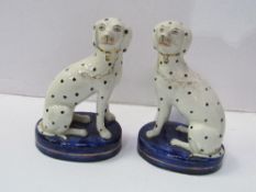 A pair of Staffordshire Dalmatian dog figurines. Estimate £80-120