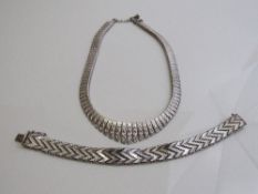 Sterling silver mesh bracelet, length 18cms, weight 1oz & a silver coloured metal flat decorative