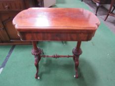 Mahogany swivel top games table, centre stretcher, turned columns to casters, frieze drawer, open