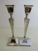 A pair of Art Deco style silver candlesticks, hallmarked Birmingham 1932, height 19cms. Estimate £