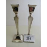 A pair of Art Deco style silver candlesticks, hallmarked Birmingham 1932, height 19cms. Estimate £