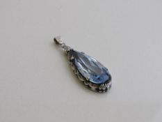 Pale blue tear drop shaped stone in silver coloured metal pendant. Estimate £40-80