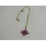 9ct gold, pink & purple star shaped pendant on 9ct gold chain, weight 1.8gms.