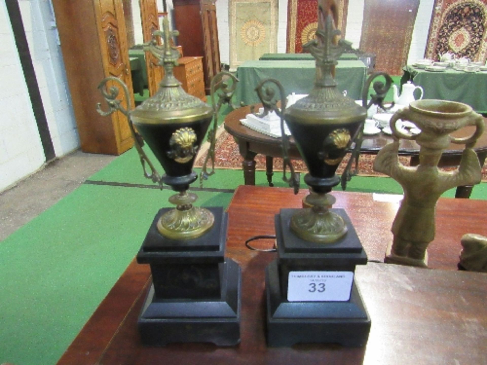 Pair of brass Grecian vase style garnitures with scrolled handles on polished black slate bases, - Image 2 of 3