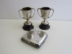 Silver cigarette case, London 1928, weight 4.9oz & 2 small silver golfing trophies on wooden stands.