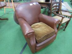 Brown faux leather armchair.