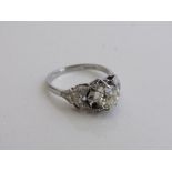 Platinum & diamond ring set with a single diamond, approx 1ct, about 6mm diameter with baguette &