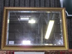 Spackle decorated gilt framed bevel edged wall mirror, 66cms x 90cms. Estimate £20-40