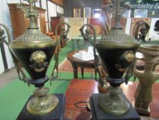 Pair of brass Grecian vase style garnitures with scrolled handles on polished black slate bases,