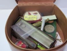 Leather collar box containing a number of small objects including coins, cigarette holders etc.