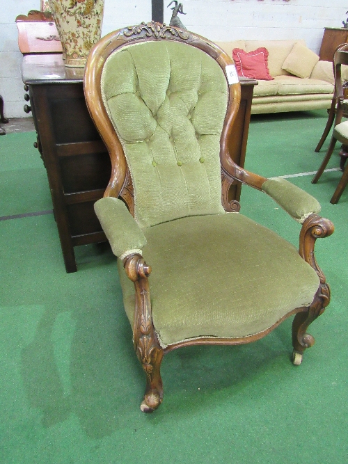 Victorian mahogany carved framed upholstered open armchair with spoon back on casters. Estimate £