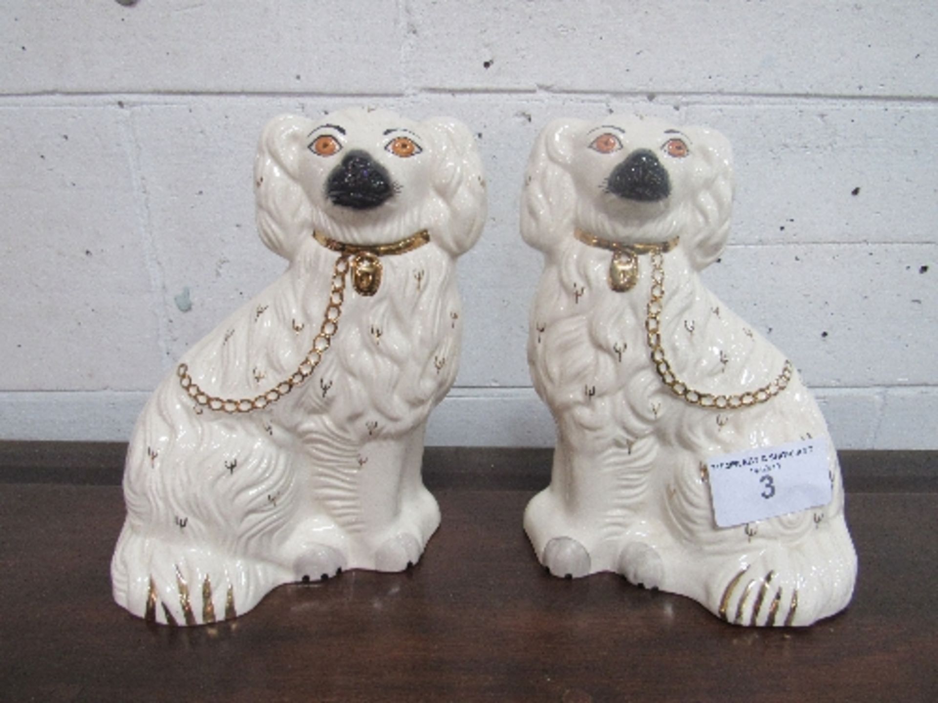 A pair of Royal Doulton white Staffordshire-type dogs. Estimate £20-30