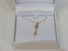 'Aray' Jewellers 9ct gold necklace with stone set key pendant, new, in box. Estimate £20-40