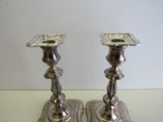 A pair of candlesticks, Sheffield 1975, height 18cms & a silver 3 branch candelabra,