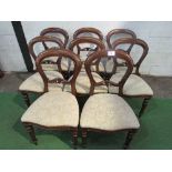 8 mahogany balloon back dining chairs with upholstered seats.